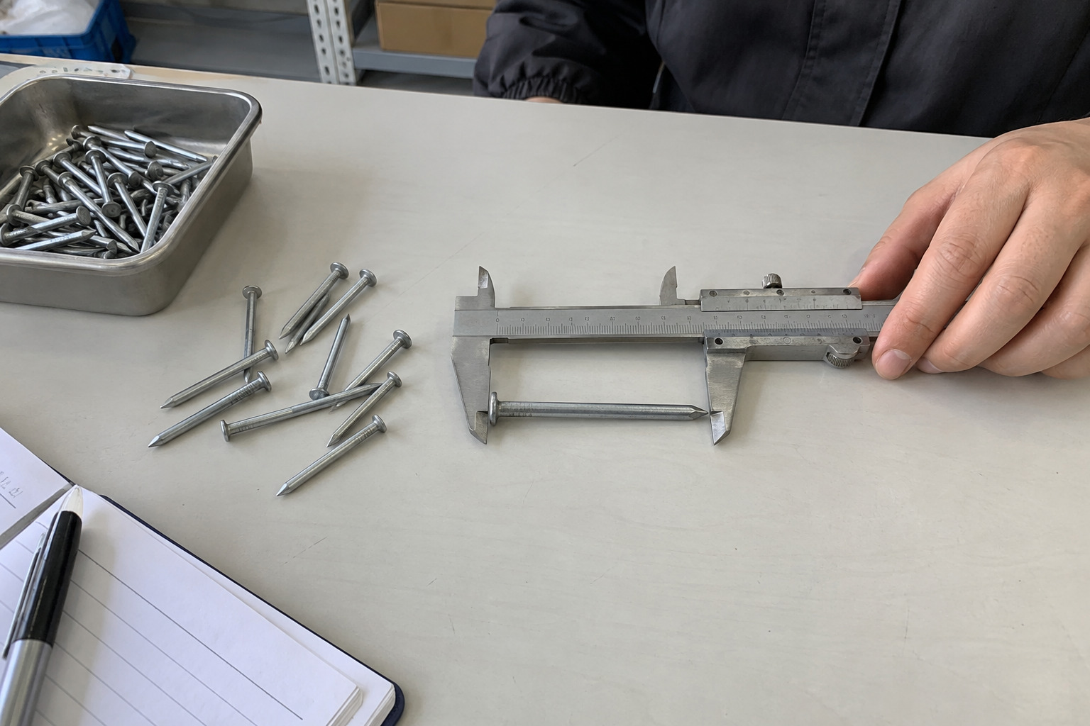 Buyer checking galvanized concrete nail specifications for brick wall fixing