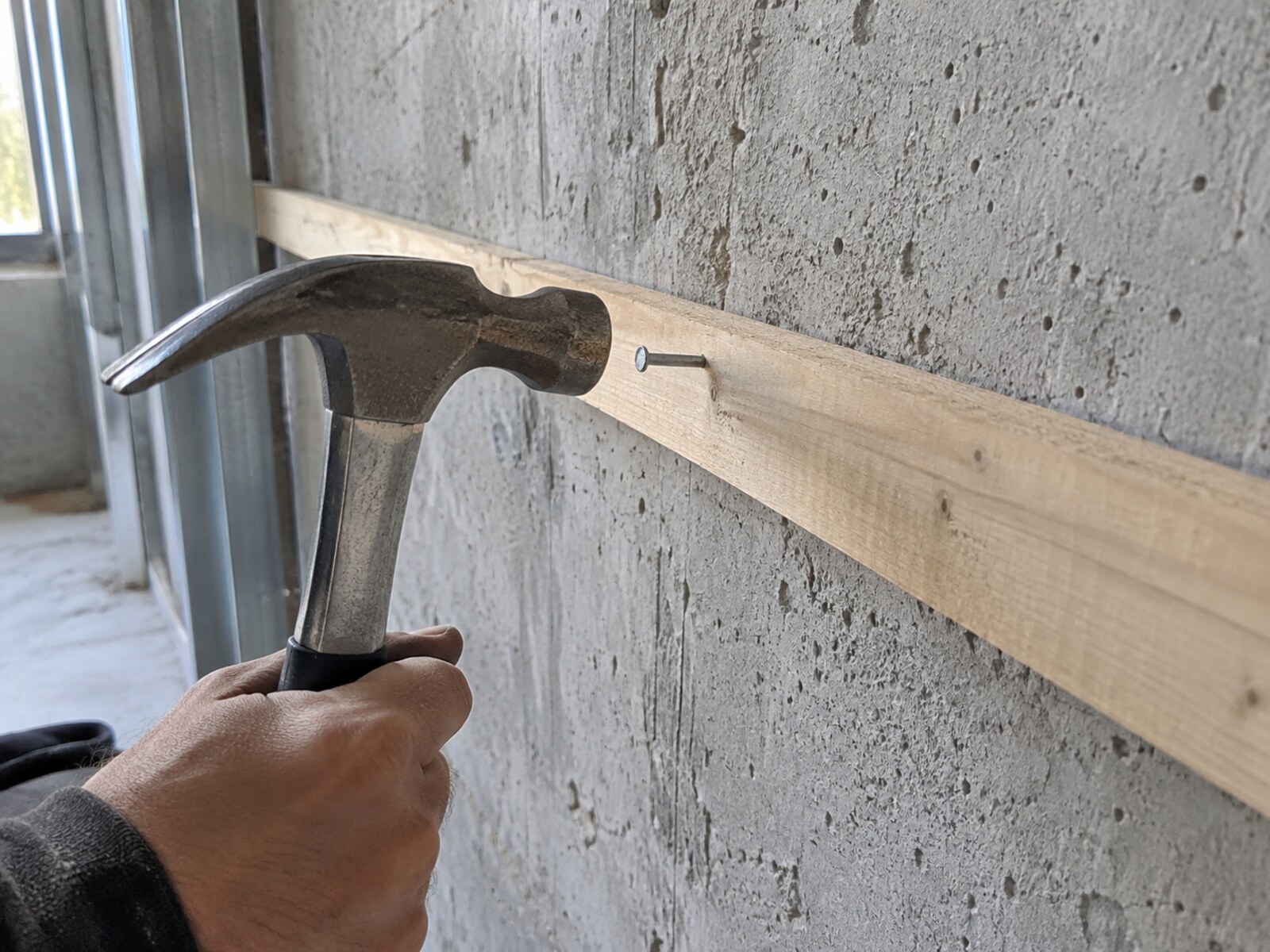 Concrete nails used for fastening materials to a concrete wall