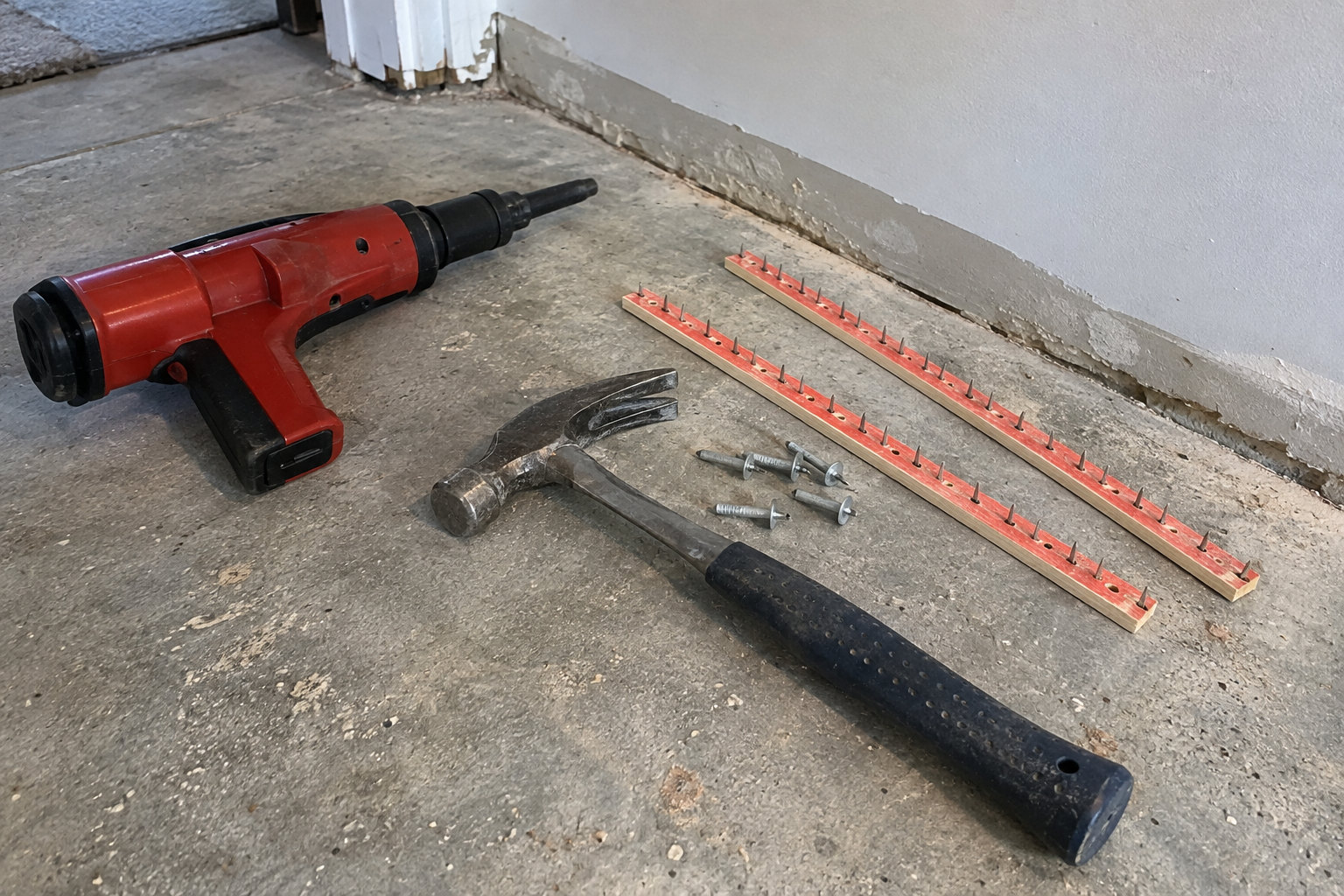 Powder-actuated tool versus hammer installation for concrete tack strips concrete tack strip installation methods powder actuated tool vs hammer